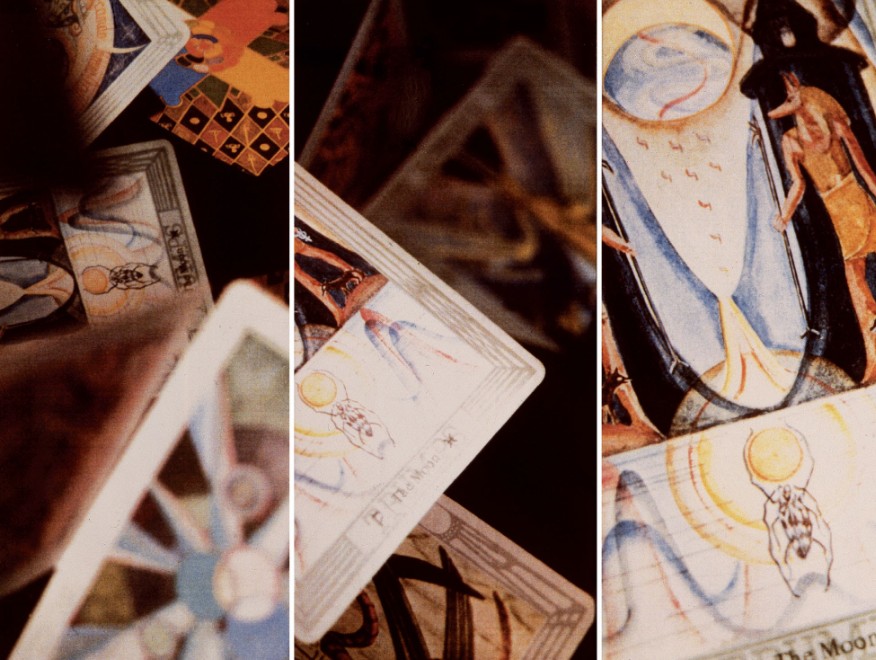 Tarot cards in three different panels shown up close