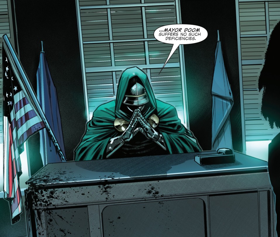 Mayor Doom sits at a desk with blood splattered across it, American flag on a pole beside him.